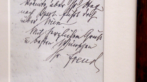 A framed handwritten letter signed “Freud.” 