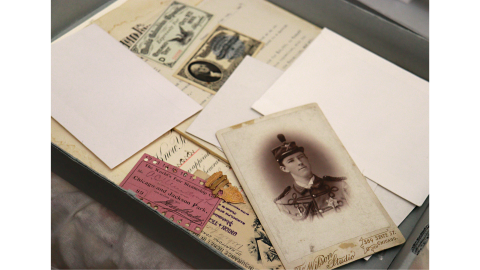 A box of historical artifacts from the 1893 World’s Fair, including admission tickets and a portrait.