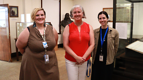 From left to right: Melissa Anderson, Gretchen Rings, and Elizabeth McKinley stand in the center of the Field Museum library.