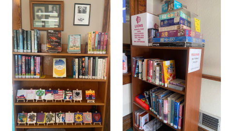 Two pictures side by side: on the left, a wood bookcase holding books on the top two shelves and mini easels with painted canvases on the bottom two shelves sits below two framed images; on the right, a wooden bookcase holding books sits against a wall, on top of the bookcase are a stack of puzzles and a box advertising eyeglass donations for the Lions Club. 