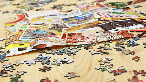 A table full of puzzle pieces. 