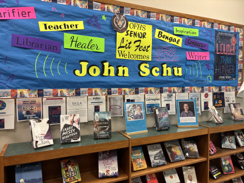 A library bulletin board dispaly for OFHS Senior Lit Fest advertises the works of John Schu. Books by John Schu are displayed on easels. 