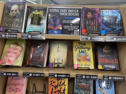 Library book display pairs various fiction works with songs that match. 