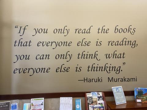 Black text on a cream wall reads, "If you only read the books that everyone else is reading, you can only think what everyone else is thinking." --Haruki Murakami. 