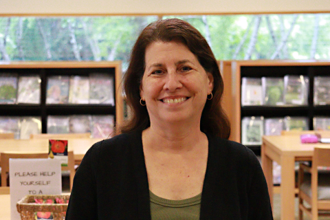 Leora Siegel stands in the center of the Chicago Botanic Garden library. 