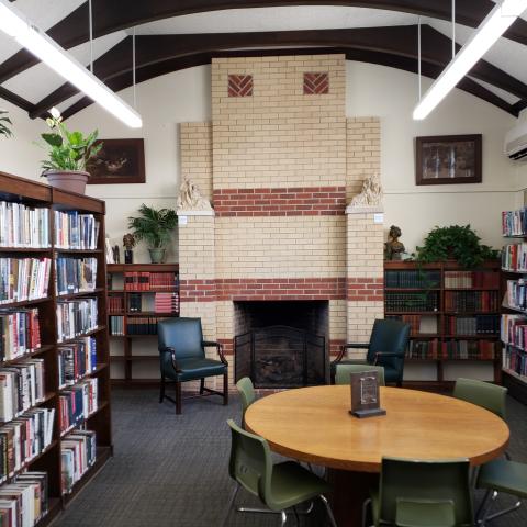 Fireplace, seating, and shelves in the Oregon Public Library.